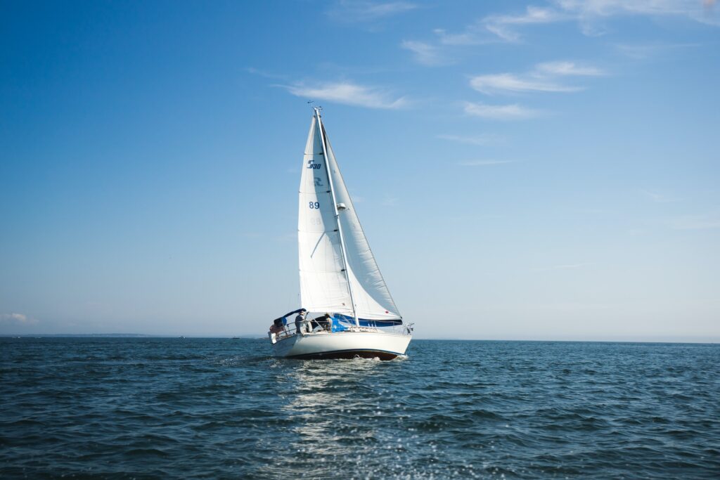 A sailing yacht out on the ocean during the day.
